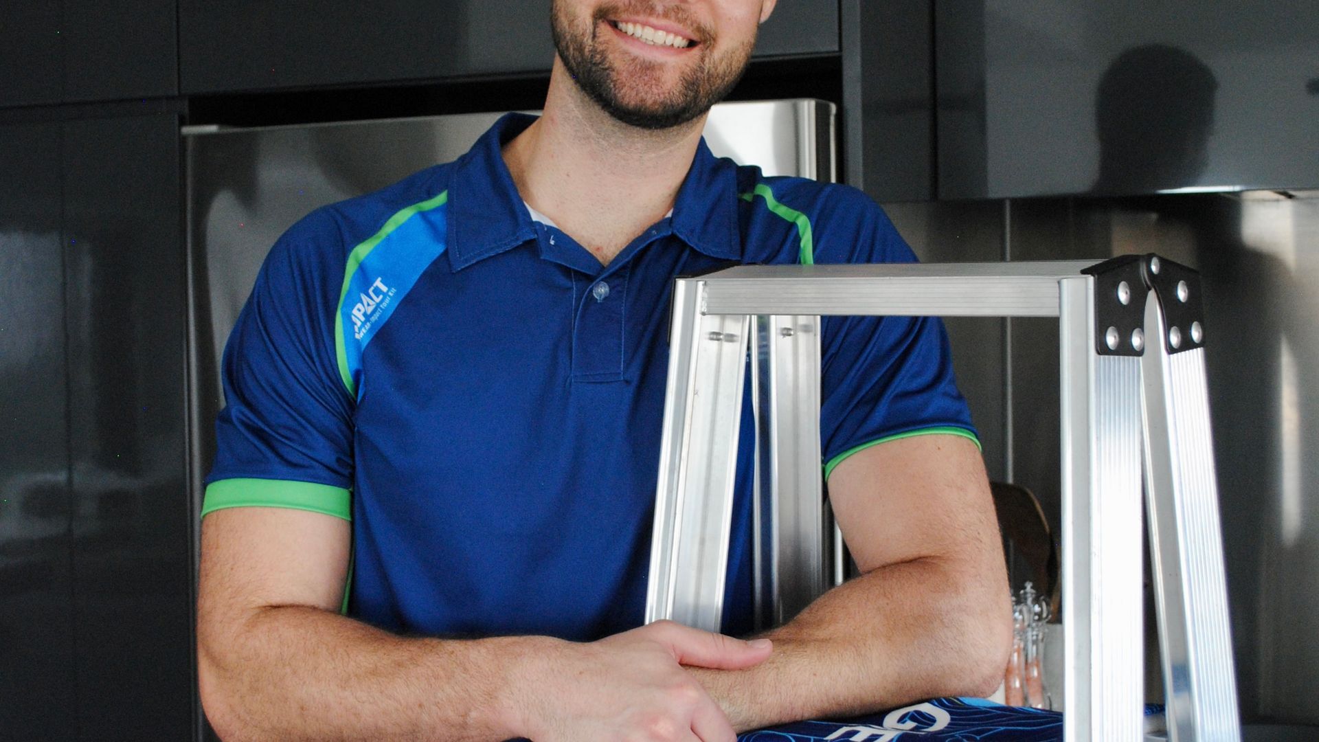 Green Clean technician standing beside a branded Green Clean equipment bag