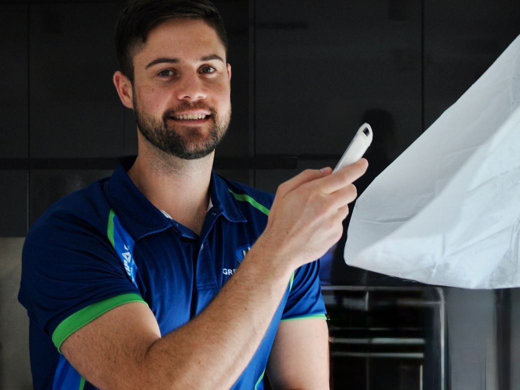 Green Clean technician holding protective sheeting in a Hong Kong kitchen